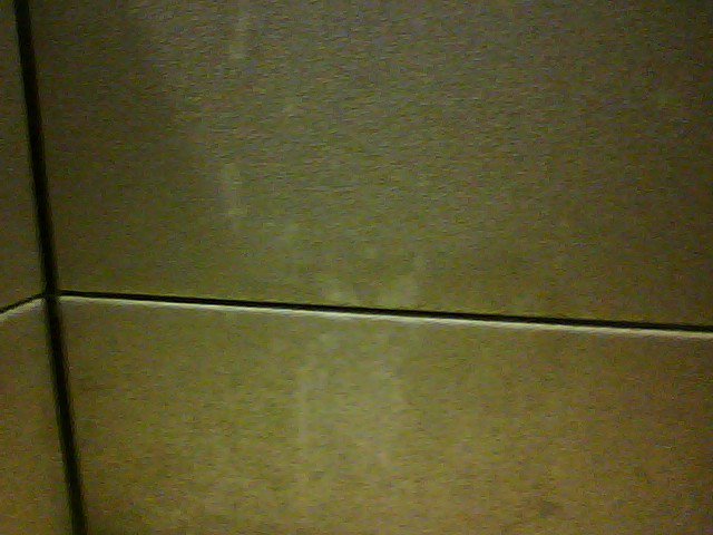 padded cloth wall of a computer station with stains